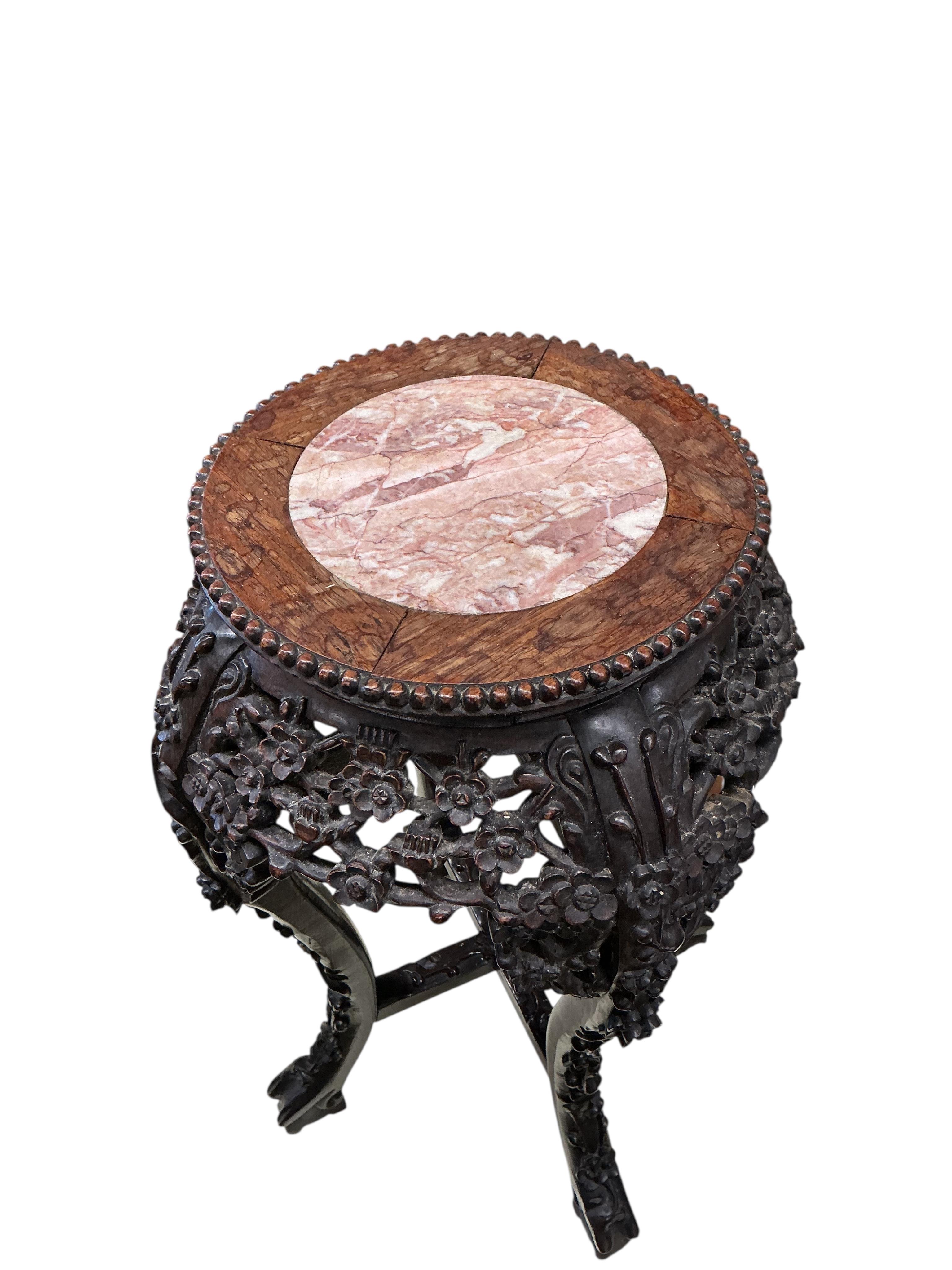 A Chinese carved padouk rouge marble topped jardiniere stand, height 60cm